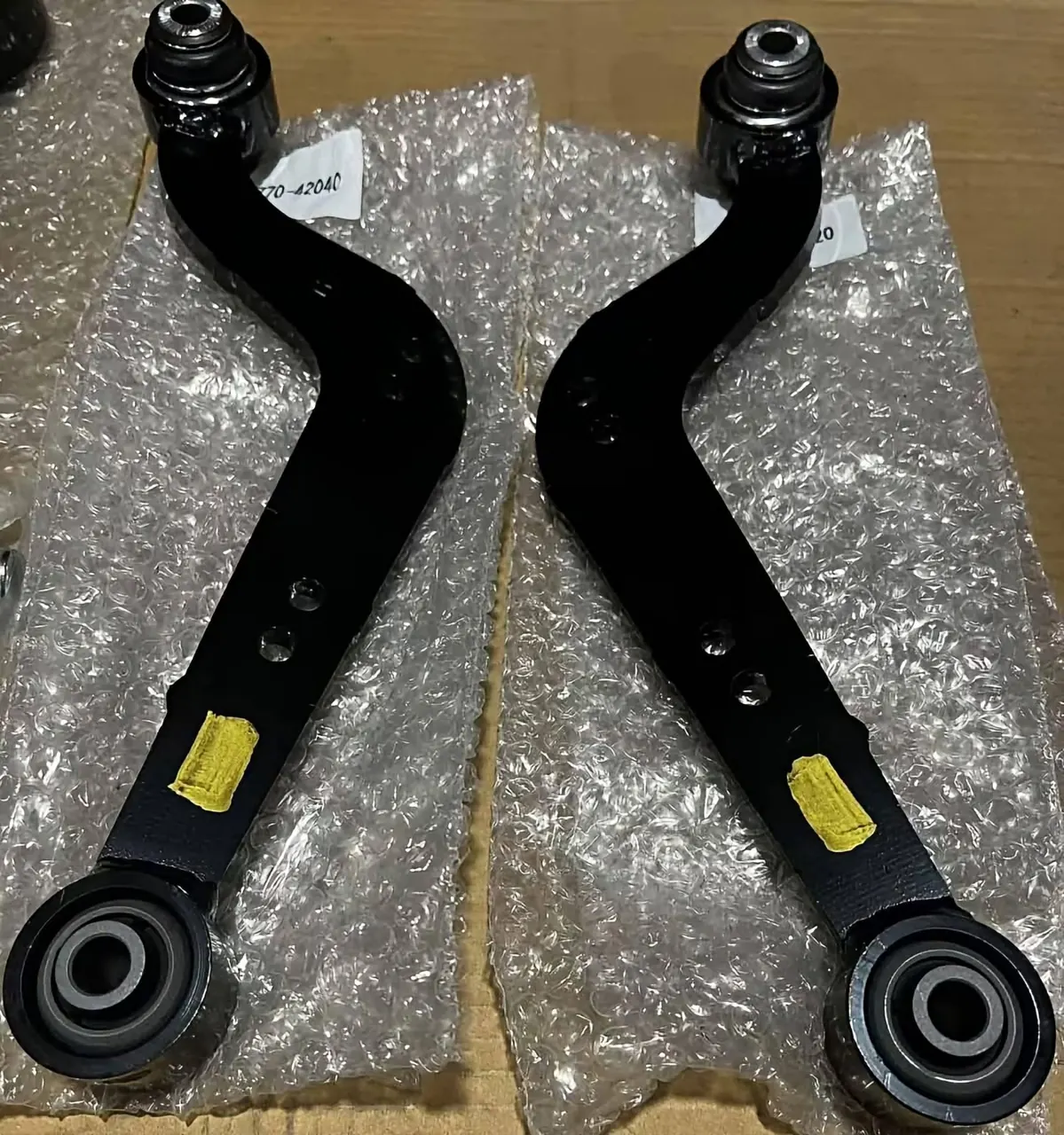 Pair of suspension control arms with bushings